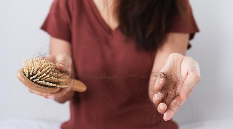 Frau mit Haarbürste in der Hand